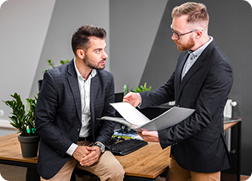 Two consultants discussing a compliance report